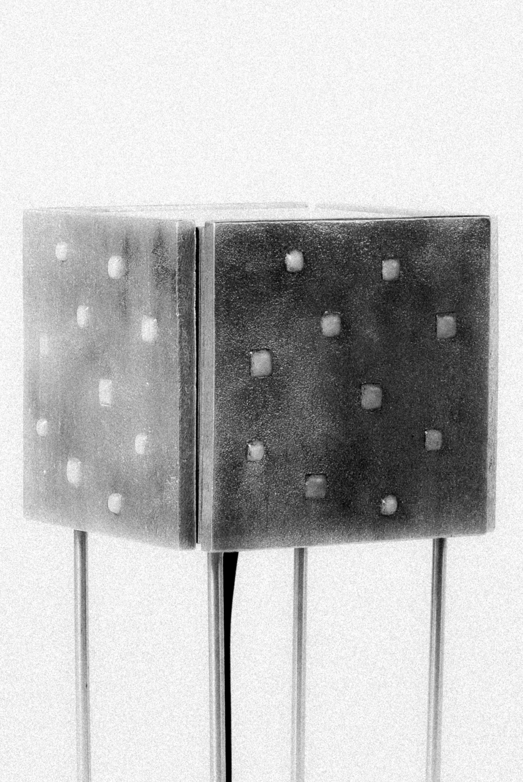 Imagem editorial em preto e brando de detalhes da luminária de mesa Prisma, da coleção Massiva, da DONÓ Design.